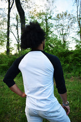 Male model wearing a baseball tee with a white body and black sleeves.