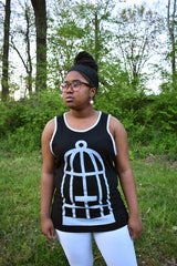 Female model wearing a black and grey ringer tank top with the No Egret's birdcage logo in grey on the front.