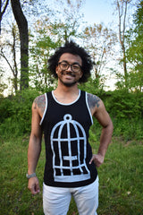 Male model wearing a black and grey ringer tank top with the No Egret's birdcage logo in grey on the front.