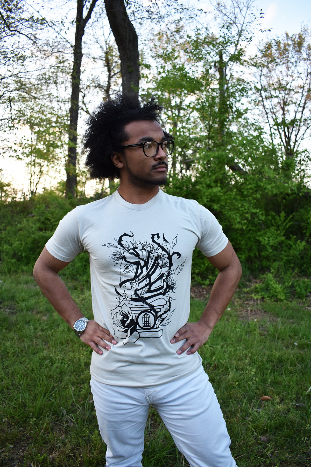 Male model wearing a cream colored t-shirt with Cameron McKnight's Knight design in black on the front.