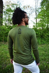 Male model wearing a green, long-sleeved shirt with a small, No Egrets Birdcage logo in black on the back in between the shoulders.